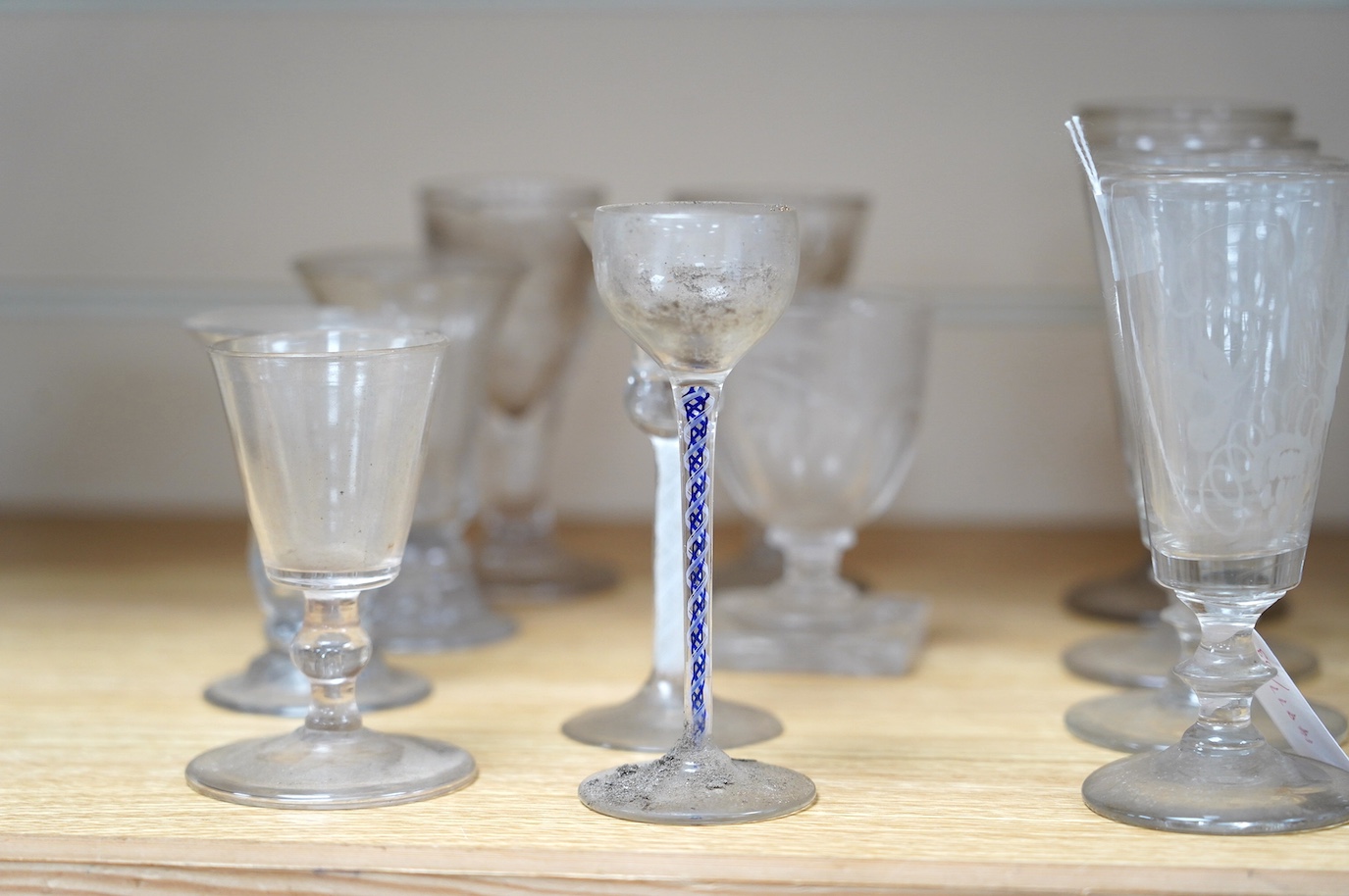 A large cut glass centrepiece, 26cm high, a pair of cut glass decanters and a collection of small glasses from 18th to 20th century. Condition - fair, difficult to see damage as most items need a thorough wash